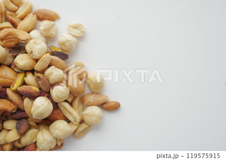 An assortment of nuts on a white background, showcasing healthy snack options for diverse tastes 119575915