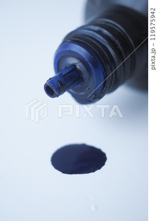 A Captivating CloseUp of a Dark Blue Ink Droplet Emerging from a Bottle as It Falls 119575942