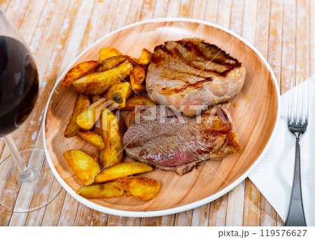 Delicious roasted veal chop served with potato Delicious roasted veal chop served with potato 119576627