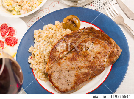 Image of tasty pearl barley with fried beef at plate on table Image of tasty pearl barley with fried beef at plate on table 119576644