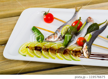 Grilled sardines with fresh vegetables Grilled sardines with fresh vegetables 119576675