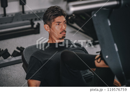 ジムで下半身を鍛える40代男性 119576759