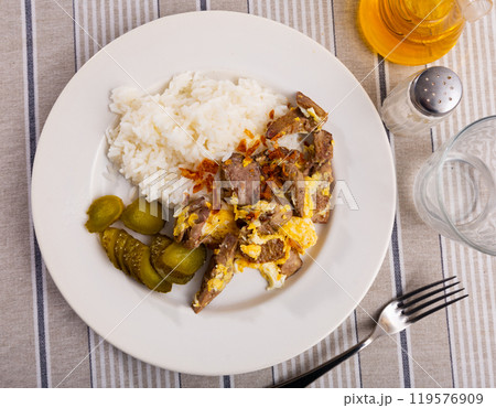 Top view white ceramic plate of flavored omelet with rabbit liver with rice and pickles 119576909