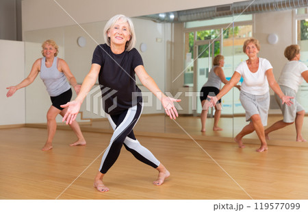 Mature dancing woman practices energetic swing Mature dancing woman practices energetic swing 119577099