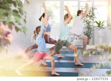 Family with two children doing pilates in studio Family with two children doing pilates in studio 119577155