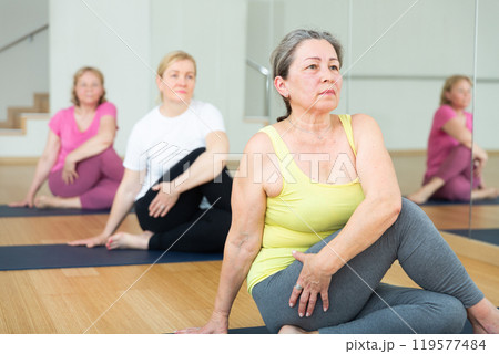 Ladies are doing lord of the fishes pose Ladies are doing lord of the fishes pose 119577484
