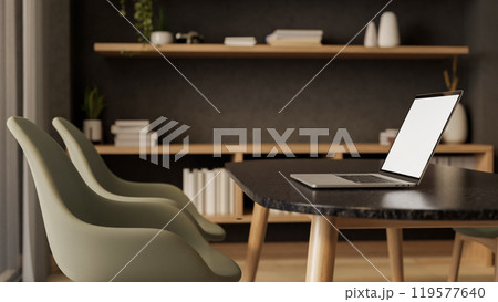 A side view of a laptop on a black dining table or meeting table in a contemporary luxurious room. 119577640