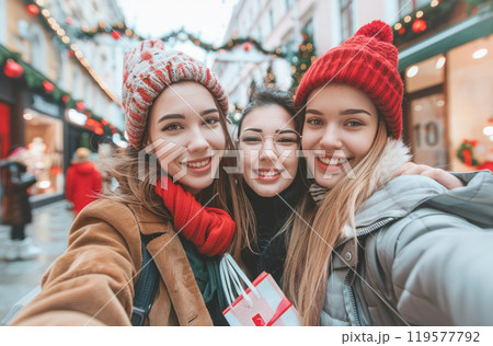 Joyful winter shopping spree with friends on a festive snowy street Joyful winter shopping spree with friends on a festive snowy street 119577792