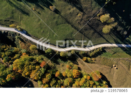 Aerial view of rural dirt village road in autumn Aerial view of rural dirt village road in autumn 119578065