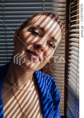 Beautiful brunette woman and blind light and shadow 119579979