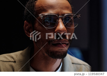 Portrait of Bearded Man Wearing Glasses with Focused Expression Portrait of Bearded Man Wearing Glasses with Focused Expression 119580347