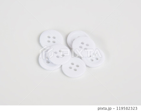 White bright cloth buttons on the white background White bright cloth buttons on the white background 119582323