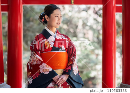 神社にお参りをする着物の女性 119583588