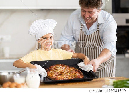 Father and daughter prepared pizza in kitchen Father and daughter prepared pizza in kitchen 119583749