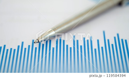 Conducting a thorough analysis of financial trends by using a pen to draw on a chart Conducting a thorough analysis of financial trends by using a pen to draw on a chart 119584394