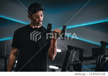ジムでダンベルトレーニングする男性 119585126