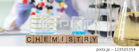 Word Chemistry against lab assistant showing molecule model Word Chemistry against lab assistant showing molecule model 119585354