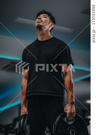 ジムでバーベルの重りを持った男性のポートレート ジムでバーベルの重りを持った男性のポートレート 119585998