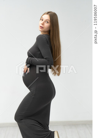 female maternity motherhood mother girl dress background positive pregnancy expectant black tummy 119586007