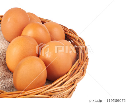 Hen natural eggs in wooden basket isolated on the white 119586073
