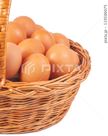 Hen natural eggs in wooden basket isolated on the white 119586075