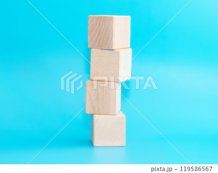 Wooden cube on blue background with space for text 119586567