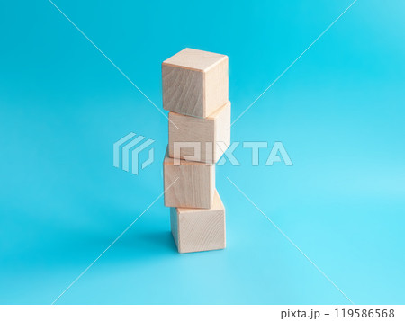 Wooden cube on blue background with space for text 119586568