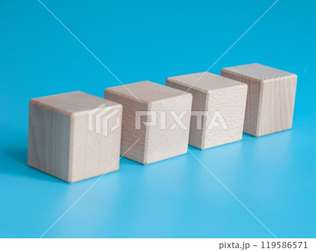 Wooden cube on blue background with space for text Wooden cube on blue background with space for text 119586571
