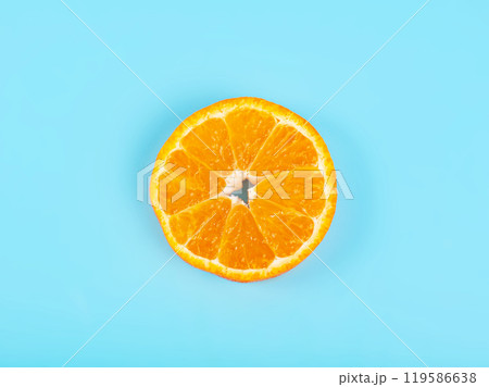 Orange tangerine slice on blue background 119586638