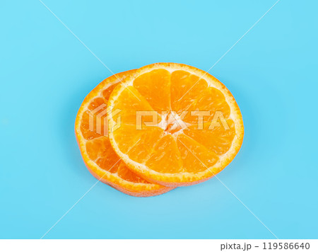 Orange tangerine slice on blue background 119586640