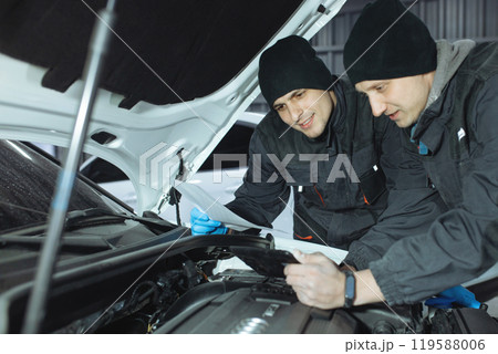 mechanic men with wrench repairing car at workshop. mechanic men with wrench repairing car at workshop. 119588006