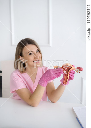 A female doctor tells and shows, using the example of an anatomical model of the uterus, about the structure of the organ and its pathologies and diseases 119592541