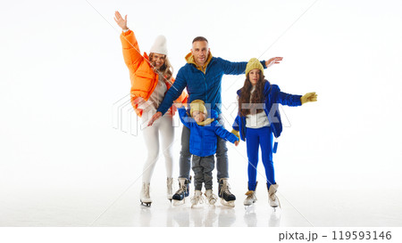 With wide smiles and open arms, family celebrates excitement of skating together during holiday season against white studio background. 119593146