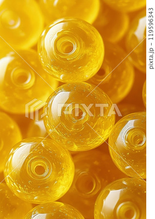 Close up view of vibrant yellow glass beads arranged together in a decorative collection 119596343