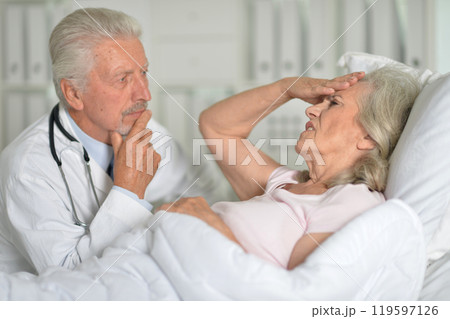 An elderly woman in the hospital with a doctor 119597126