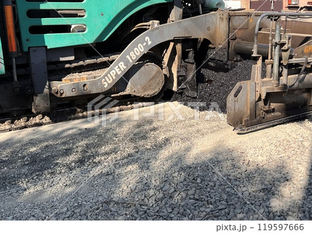 Asphalt paving roller. Road roller laying fresh asphalt, working on the new road construction site 119597666
