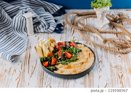 Mediterranean hummus plate with fresh vegetables, olives, and pita bread for a perfect meal Mediterranean hummus plate with fresh vegetables, olives, and pita bread for a perfect meal 119598567