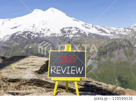 Planning 2025 review new year symbol. Concept words 2025 Review on beautiful yellow chalk blackboard. Beautiful mountain Elbrus background. Business 2025 review new year concept. Copy space. 119599316