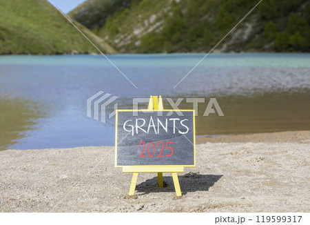 Planning grants 2025 new year symbol. Concept words Grants 2025 on beautiful yellow chalk blackboard. Beautiful mountain lake sand beach background. Business grants 2025 new year concept. Copy space. 119599317