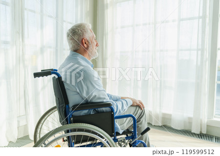 Sad senior man sitting in wheelchair looking out window in retirement home hospital. Old paralyzed man in chair for people with disability feel depressed. Lonely elderly sick man sitting on wheelchair Sad senior man sitting in wheelchair looking out window in retirement home hospital. Old paralyzed man in chair for people with disability feel depressed. Lonely elderly sick man sitting on wheelchair 119599512