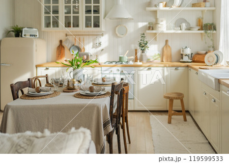 Scandinavian classic minimalistic kitchen with white and wooden details flowers. Modern white kitchen clean contemporary style interior design. Empty bright white interior minimal of kitchen 119599533