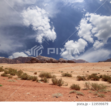 Wadi Rum Desert also known as The Valley of the Moon (against the sky with clouds)-- is a valley cut into the sandstone and granite rock in southern Jordan 60 km to the east of Aqaba Wadi Rum Desert also known as The Valley of the Moon (against the sky with clouds)-- is a valley cut into the sandstone and granite rock in southern Jordan 60 km to the east of Aqaba 119599879