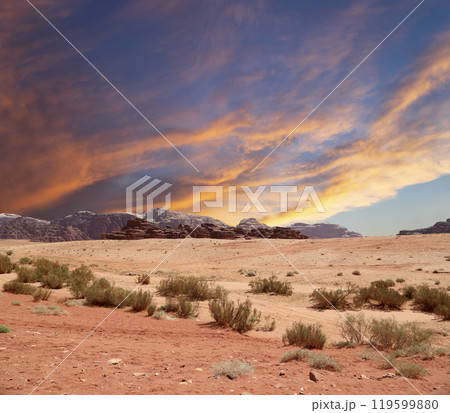 Wadi Rum Desert also known as The Valley of the Moon (against the sky with clouds)-- is a valley cut into the sandstone and granite rock in southern Jordan 60 km to the east of Aqaba 119599880