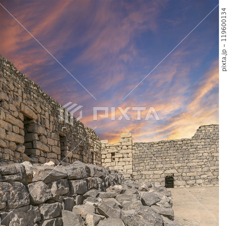 Ruins of Azraq Castle (Qasr al-Azraq) is a crusader castle (300AD),  central-eastern Jordan, 100 km east of Amman, Jordan. Against the background of a beautiful sky with clouds 119600134