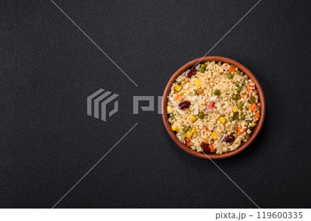 Boiled wheat bulgur porridge with vegetables peppers, peas, corn Boiled wheat bulgur porridge with vegetables peppers, peas, corn 119600335