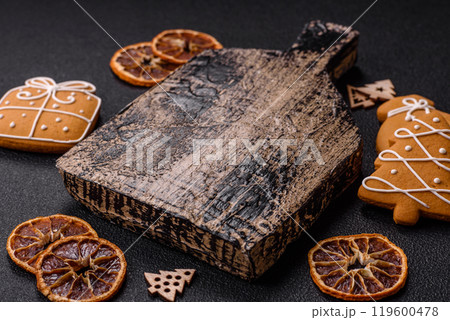Empty wooden cutting board with copy space with gingerbread cookies and Christmas decor Empty wooden cutting board with copy space with gingerbread cookies and Christmas decor 119600478