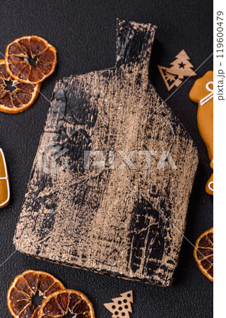 Empty wooden cutting board with copy space with gingerbread cookies and Christmas decor 119600479