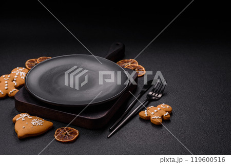Empty round ceramic copy space plate with gingerbread cookies and Christmas elements Empty round ceramic copy space plate with gingerbread cookies and Christmas elements 119600516