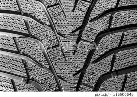 Modern winter tire tread closeup that has passed the braking test on ice Modern winter tire tread closeup that has passed the braking test on ice 119600649