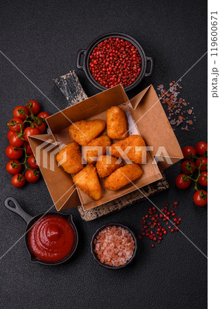 Breaded camembert or brie cheese baked in the form of nuggets with salt and spices 119600671